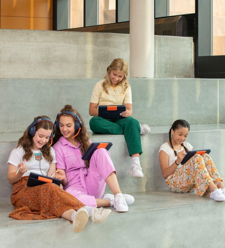 Group of students engaging with tablet-based learning tools, using digital pens and audio headsets to create, annotate, and share educational content.